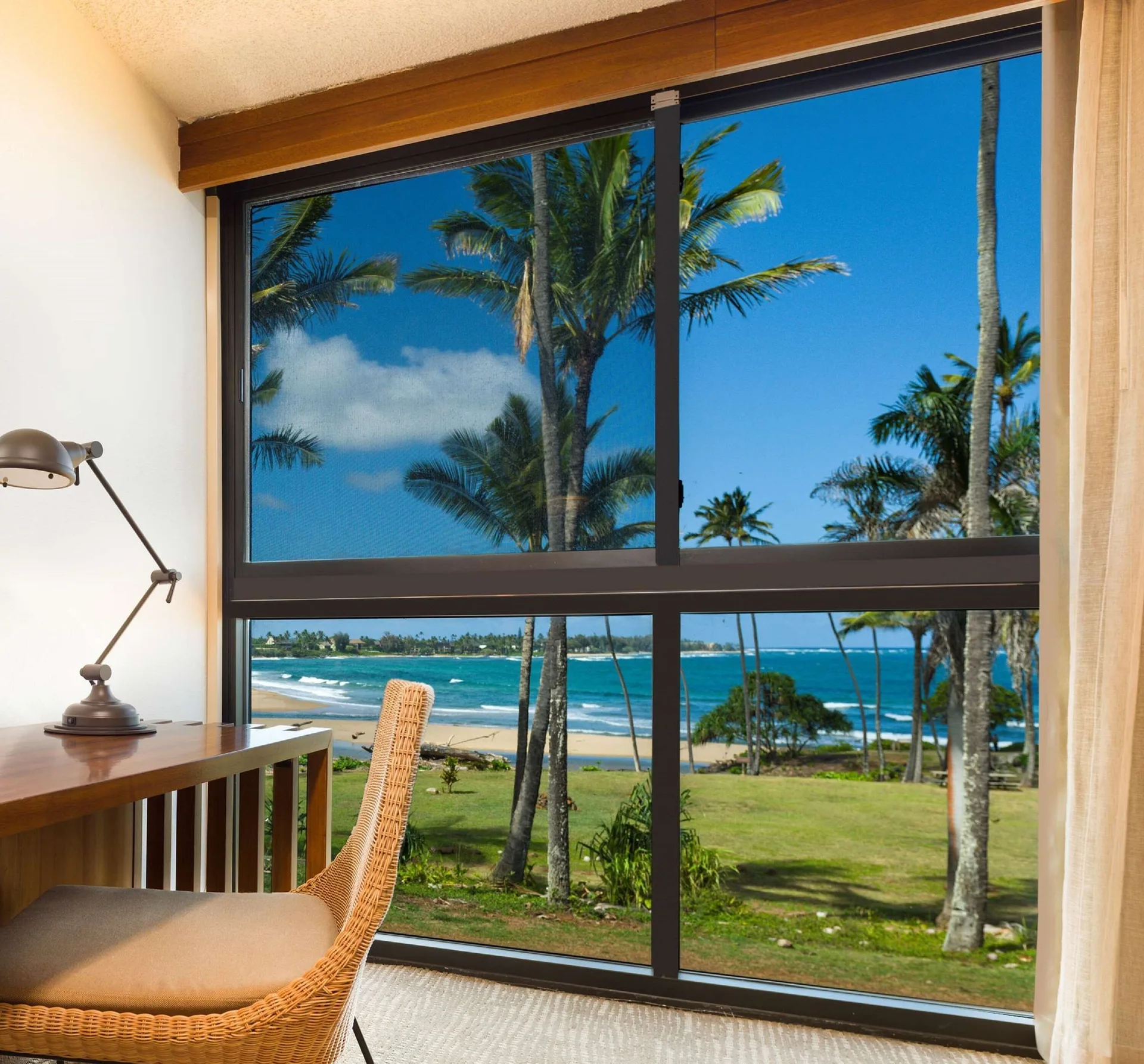 Ocean view room window at Hilton Garden Inn Kauai Wailua Bay with palms, beach, and blue water.