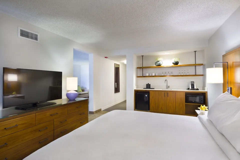 Accessible suite bedroom with king bed and wet bar at Hilton Garden Inn Kauai Wailua Bay.