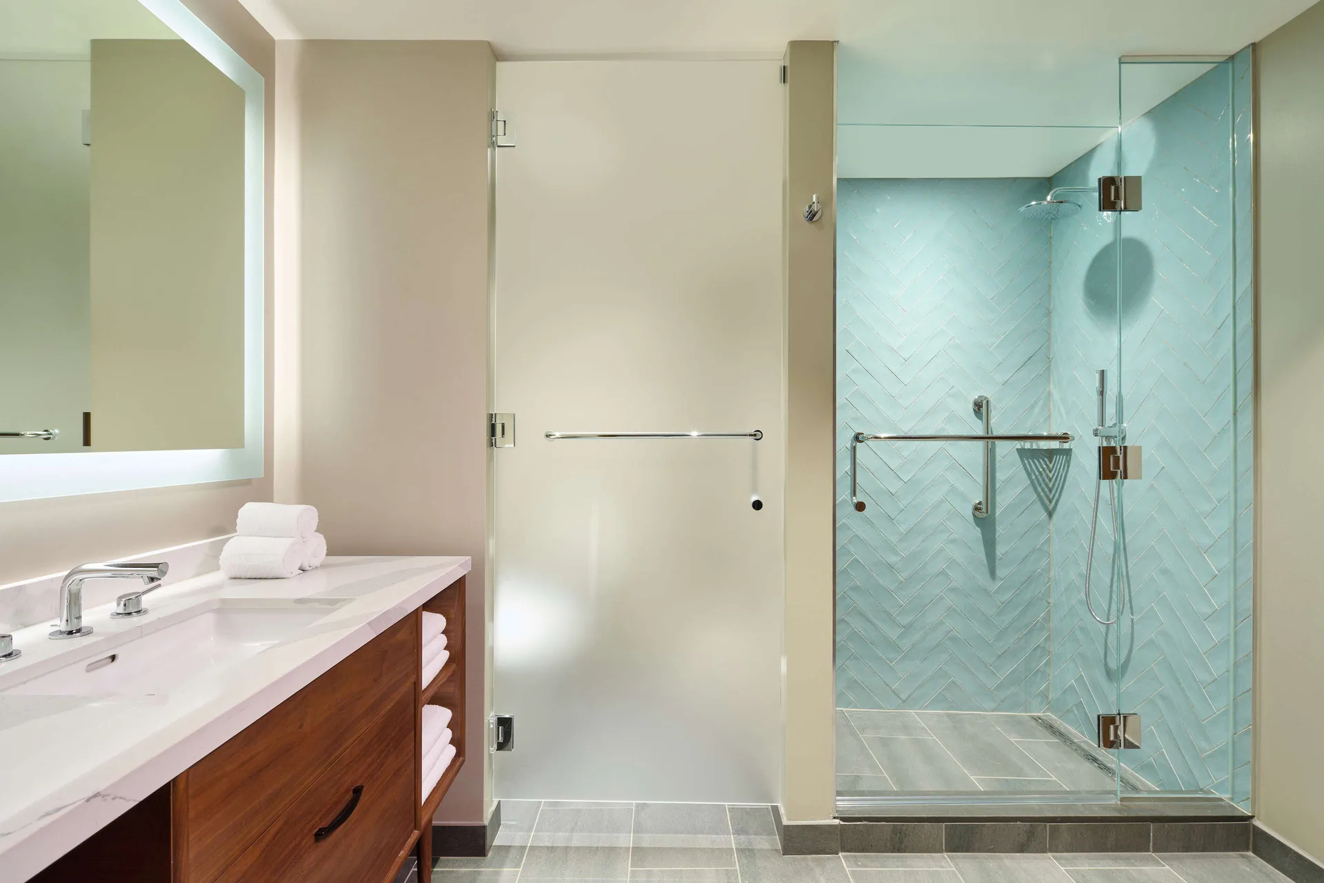 Bathroom vanity and glass shower in a suite at Hilton Grand Vacations Club Maui Bay Villas.