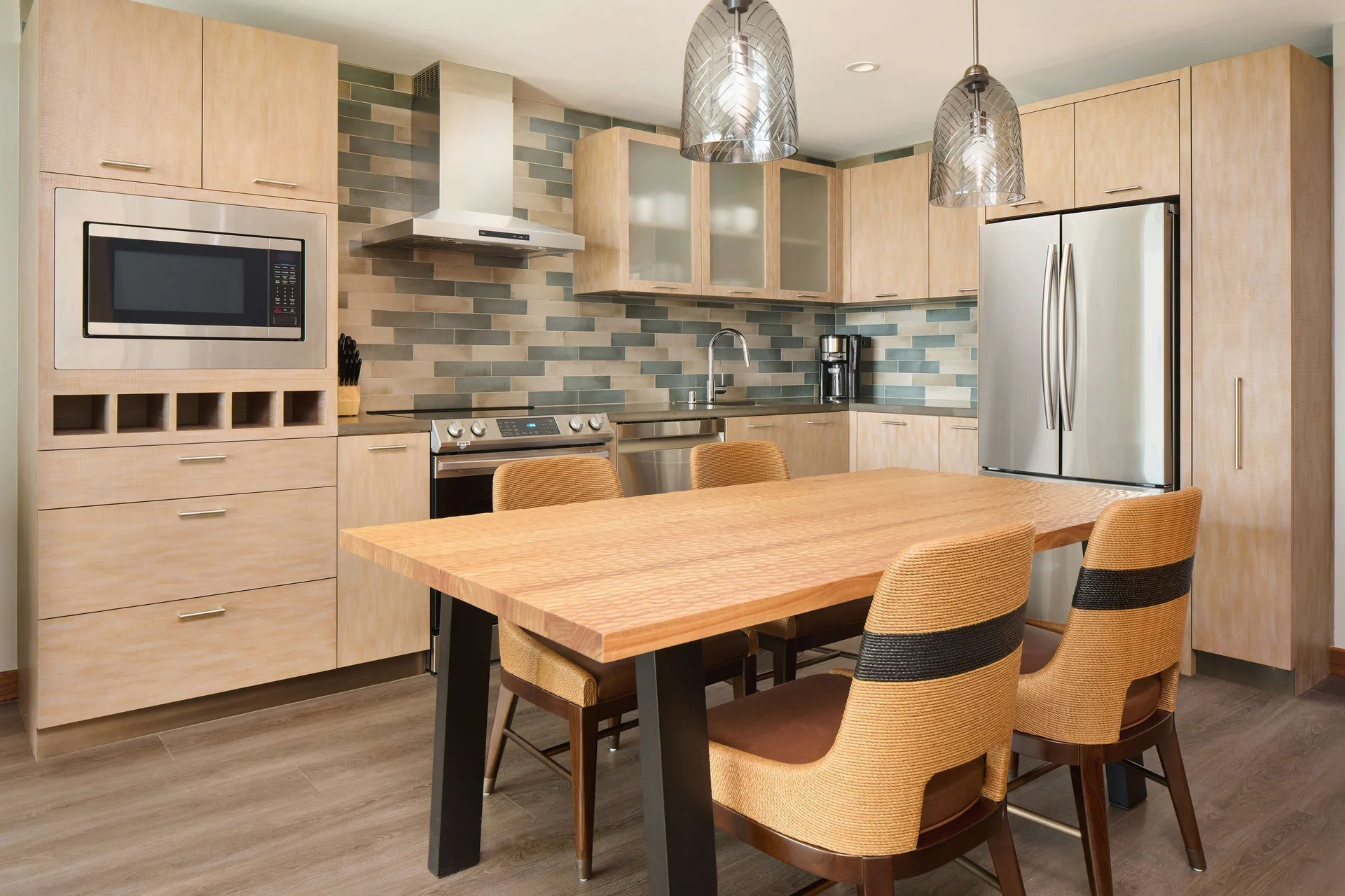 Kitchen and dining table in a resort view suite at Hilton Grand Vacations Club Maui Bay Villas.