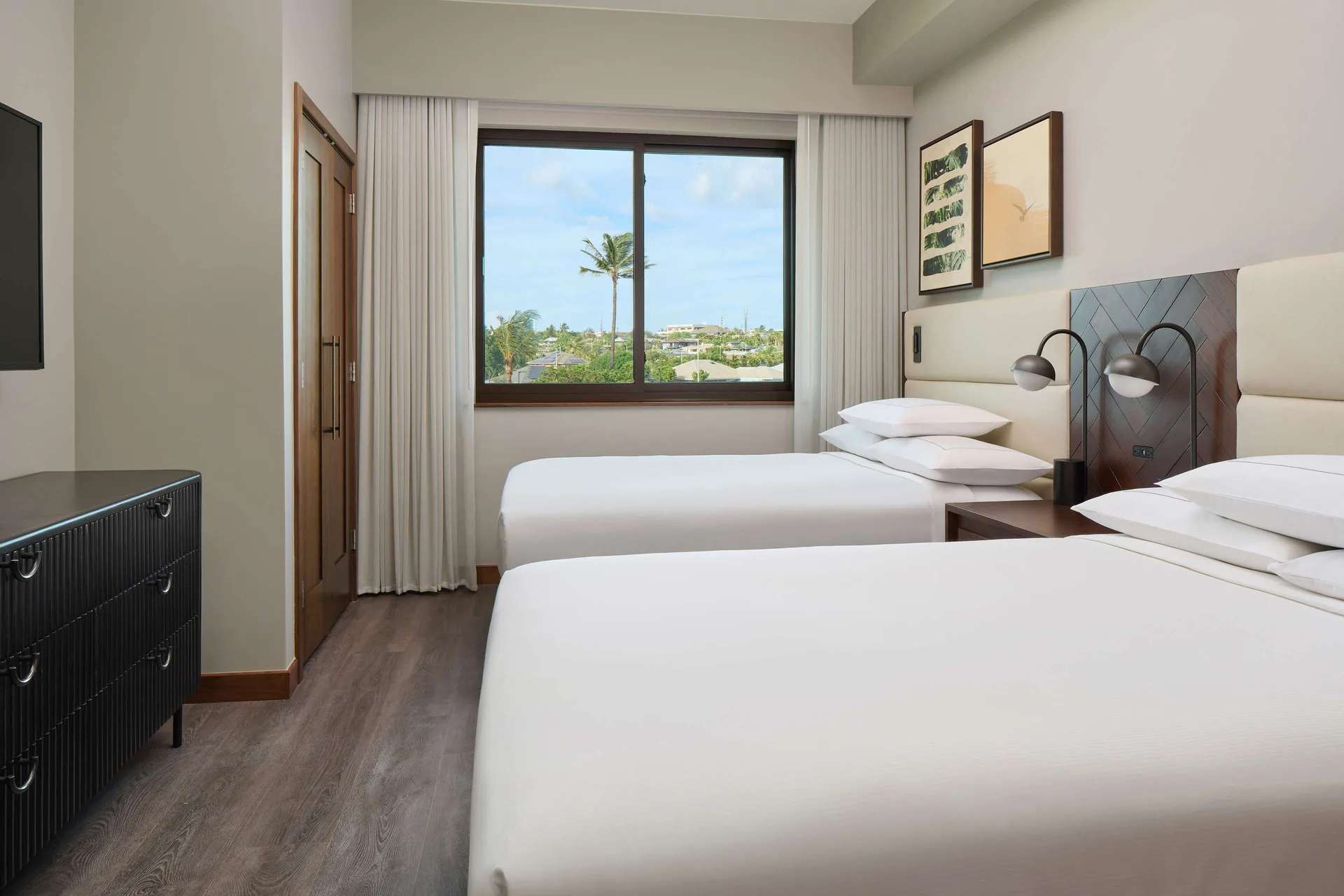 Two-bed bedroom with resort view window at Hilton Grand Vacations Club Maui Bay Villas.