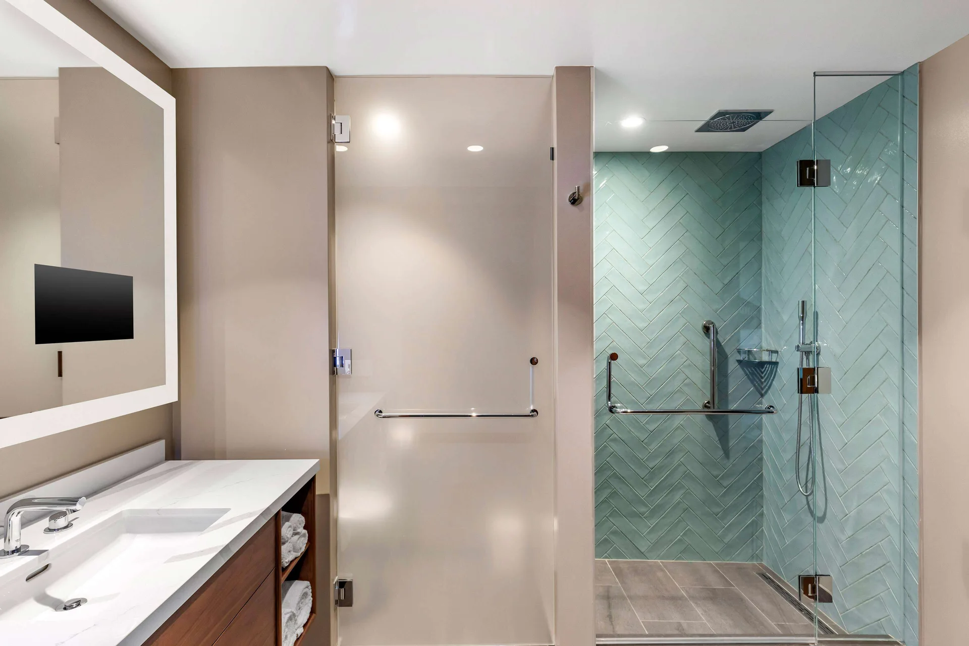 One-bedroom suite bathroom with vanity and glass shower at Hilton Grand Vacations Club Maui Bay Villas.