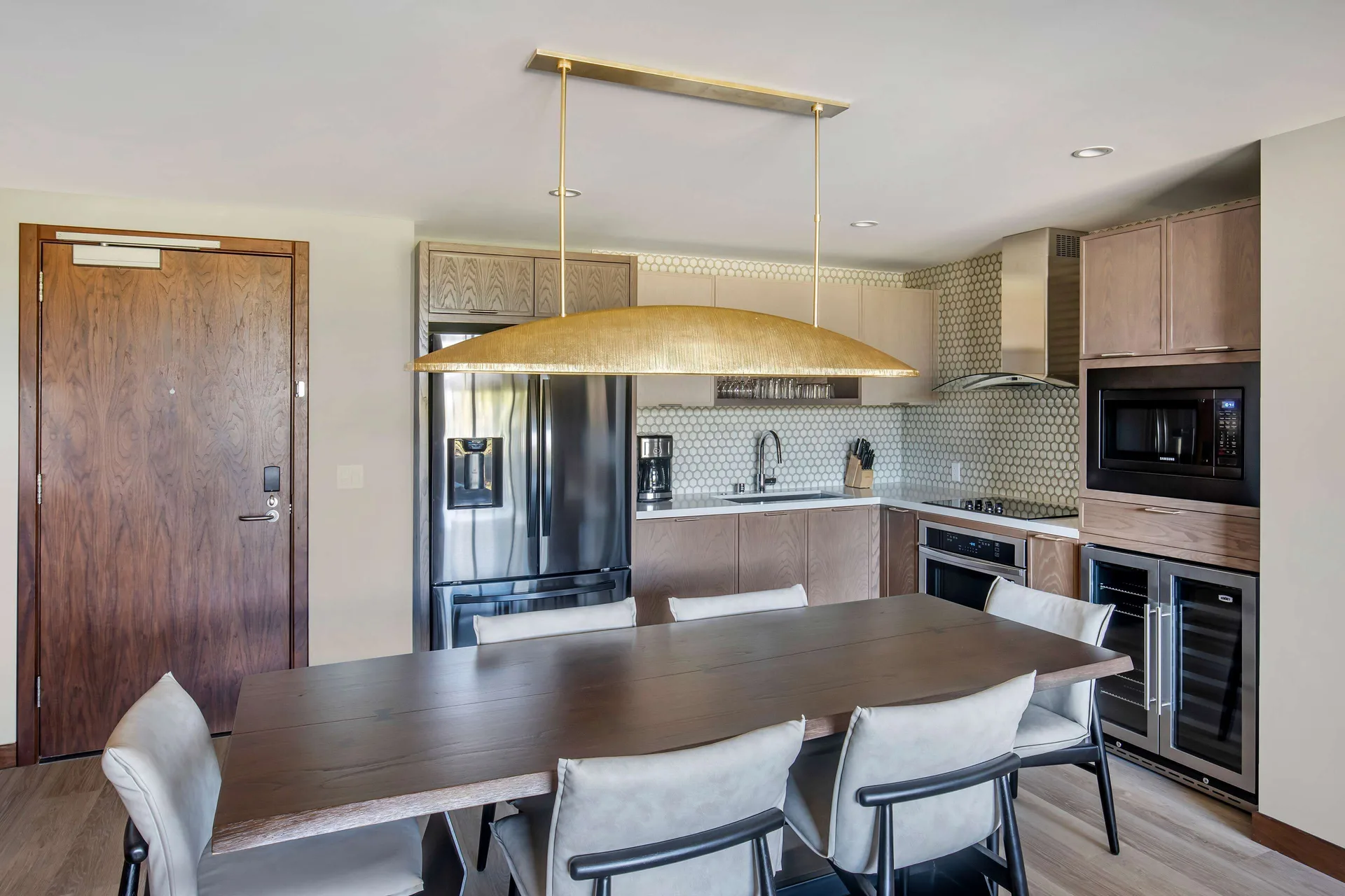 Suite dining table and full kitchen at Hilton Grand Vacations Club Maui Bay Villas.