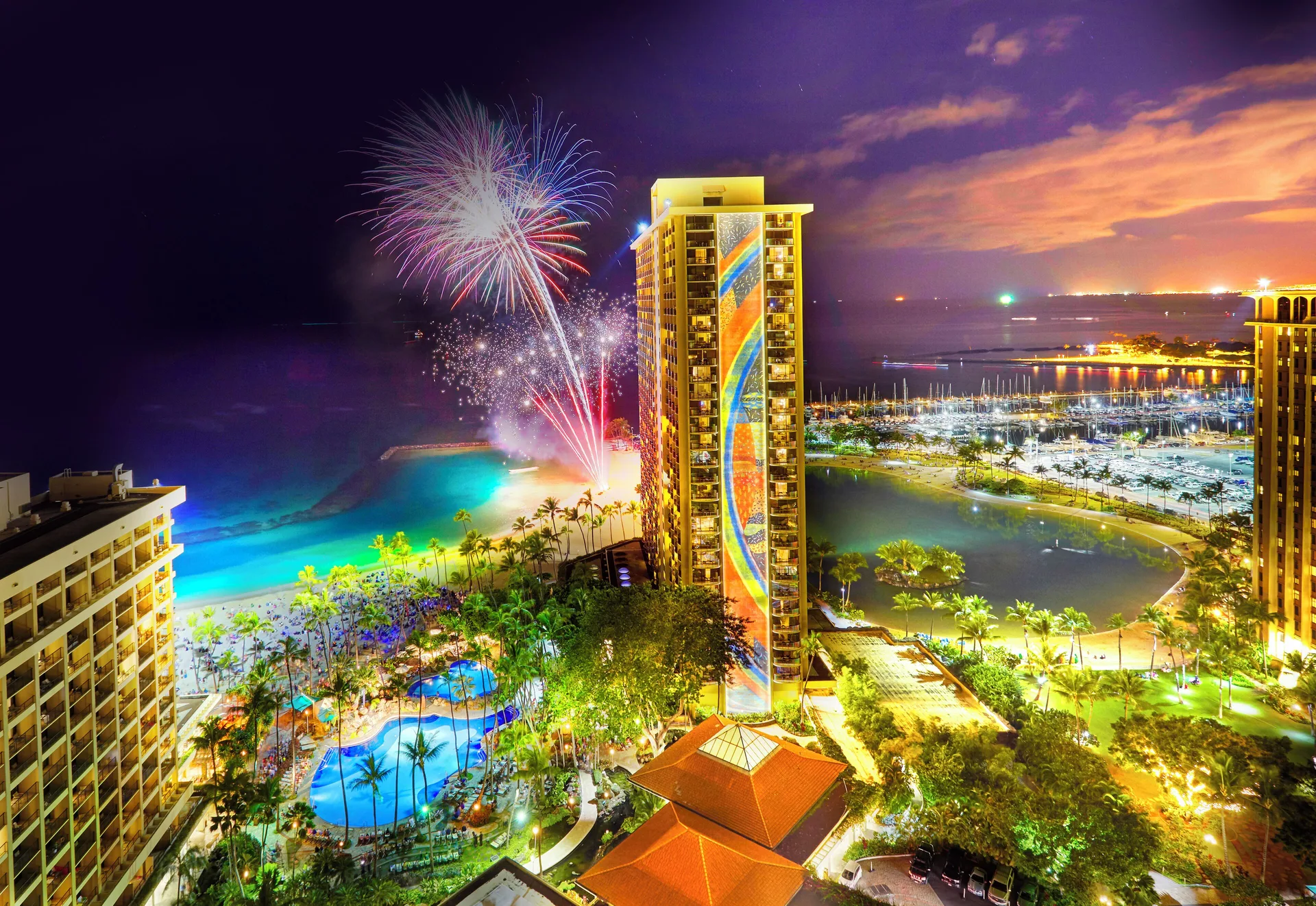 Fireworks over the resort towers and lagoon at Hilton Hawaiian Village Waikiki Beach Resort.