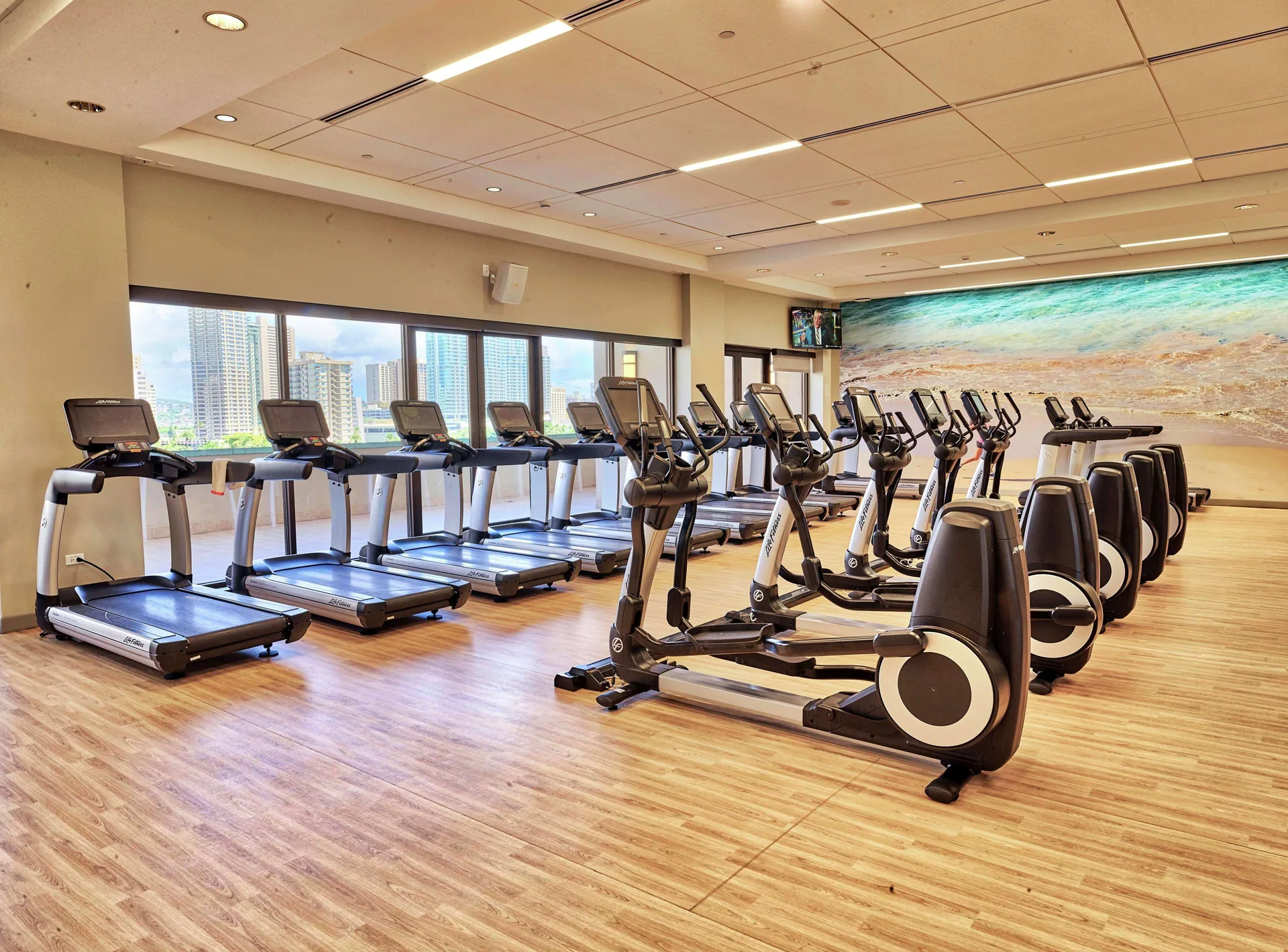 Fitness room with treadmills and cardio machines at Hilton Hawaiian Village Waikiki Beach Resort.