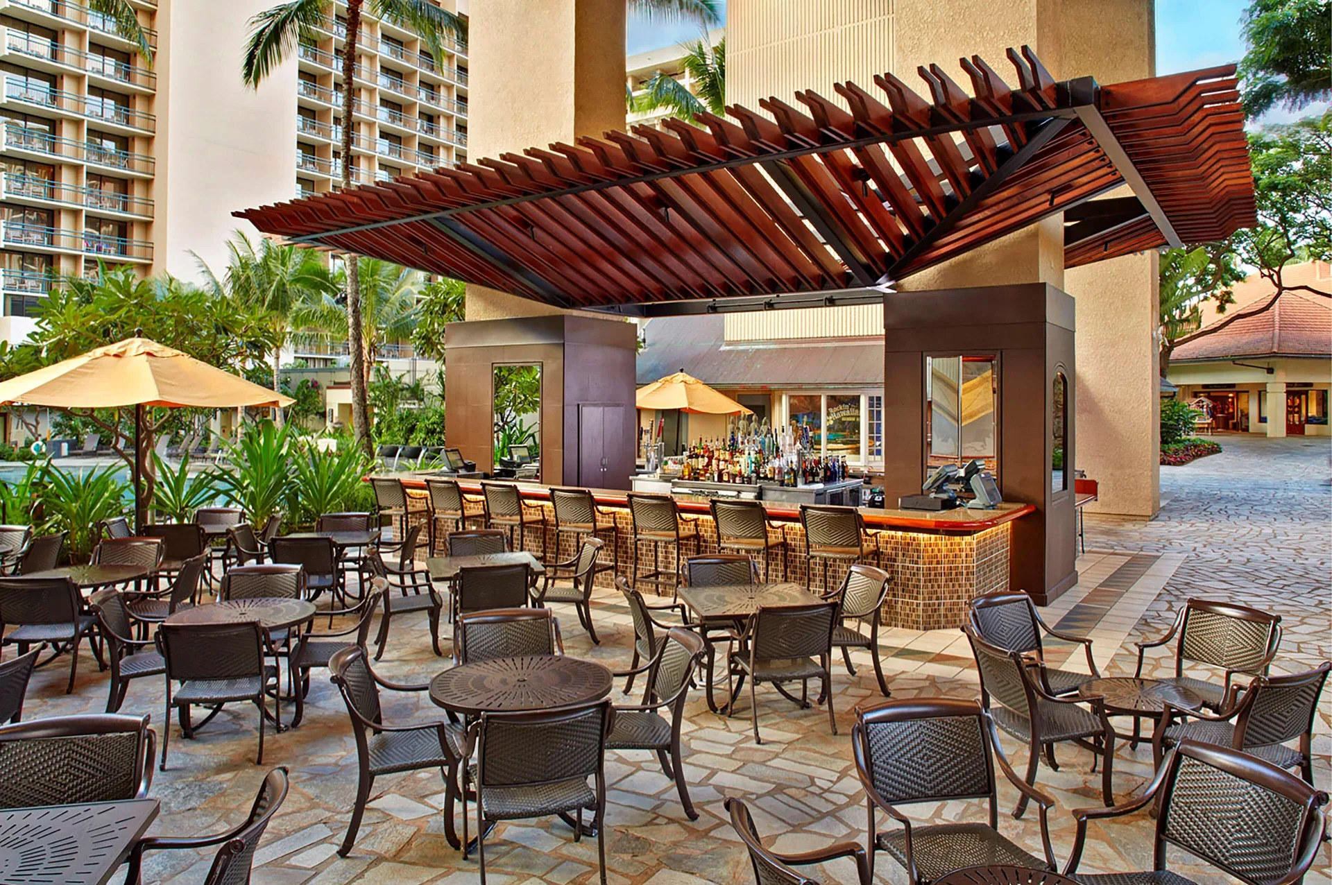 Outdoor poolside bar seating at Hilton Hawaiian Village Waikiki Beach Resort.