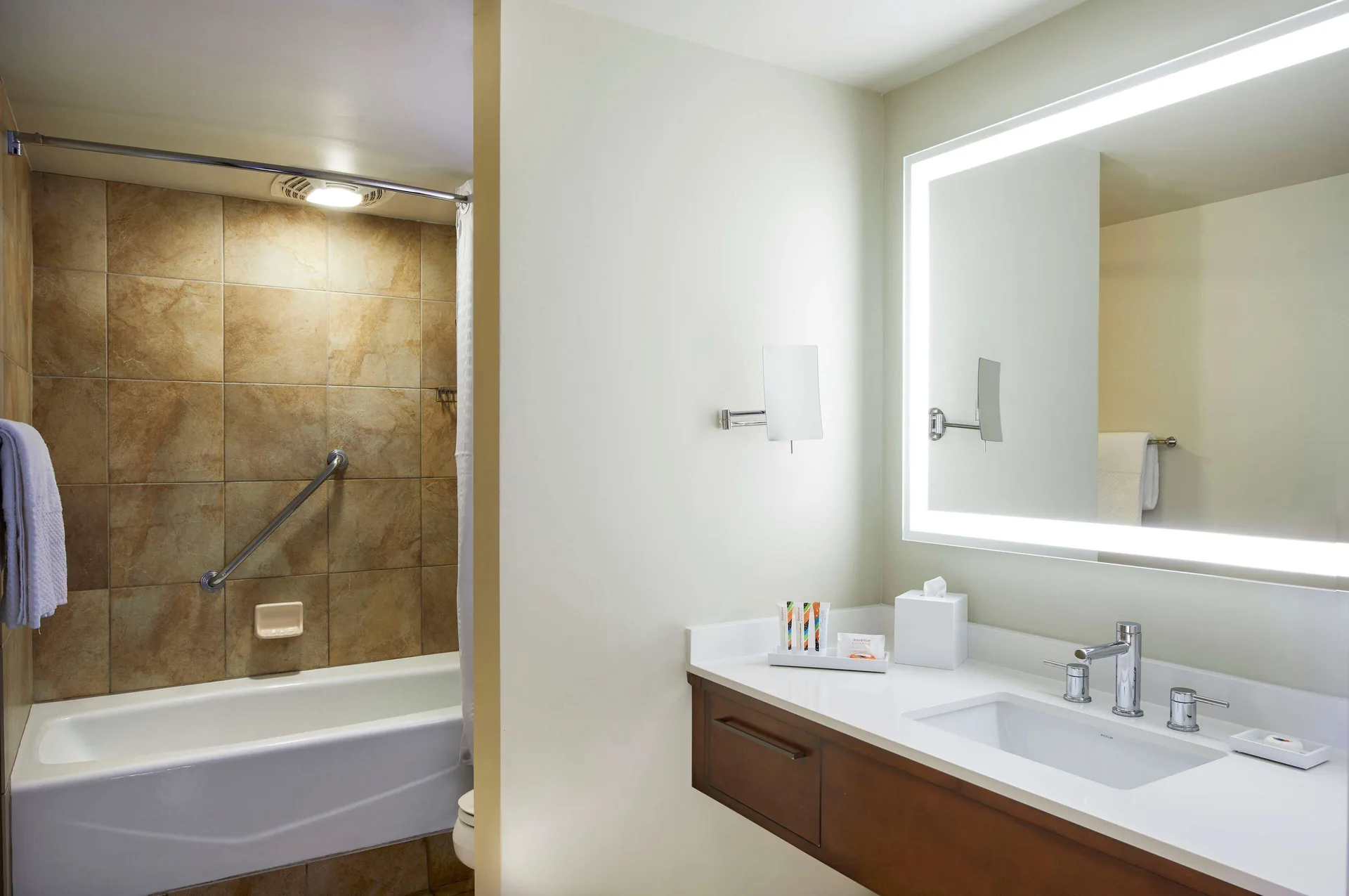 Bathroom vanity and tub in a Tapa Collection family room at Hilton Hawaiian Village Waikiki Beach Resort.