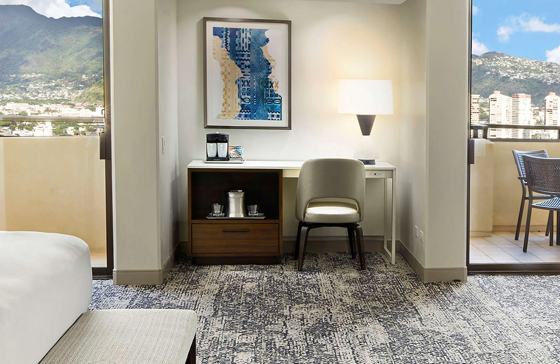 Desk alcove and balcony views in a Tapa Collection family room at Hilton Hawaiian Village Waikiki Beach Resort.