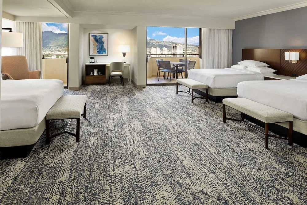 Spacious Tapa Collection family room with multiple beds at Hilton Hawaiian Village Waikiki Beach Resort.