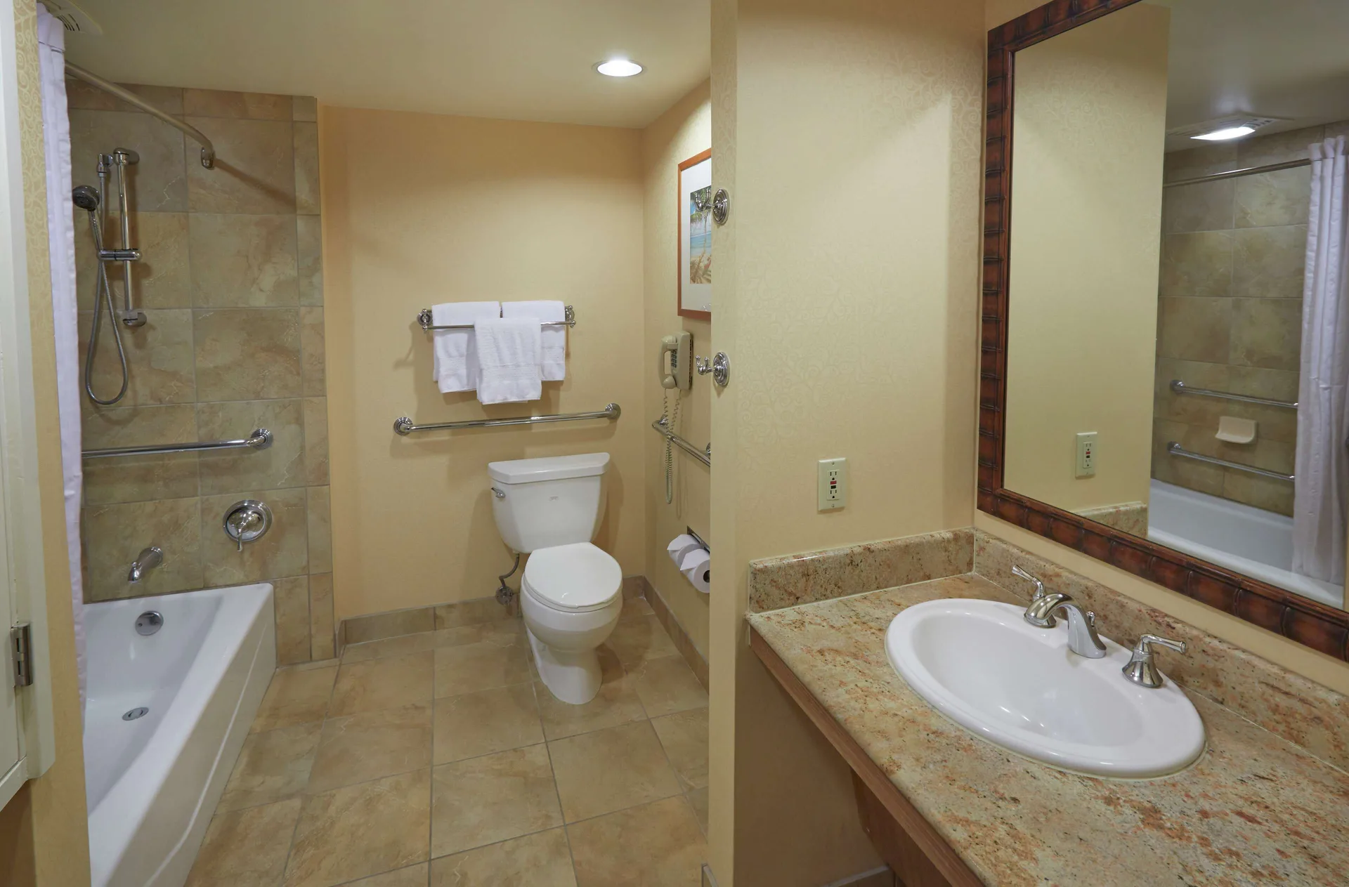 Accessible bathtub room bathroom at Hilton Hawaiian Village Waikiki Beach Resort with grab bars and vanity.