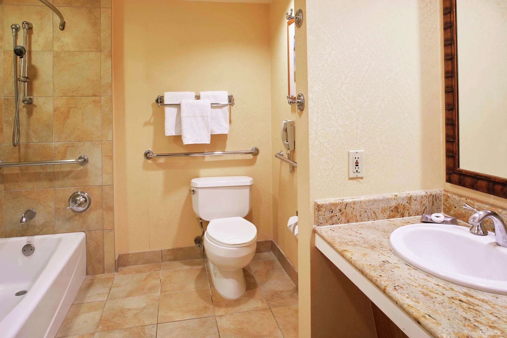Accessible bathroom vanity, toilet, and tub at Hilton Hawaiian Village Waikiki Beach Resort.
