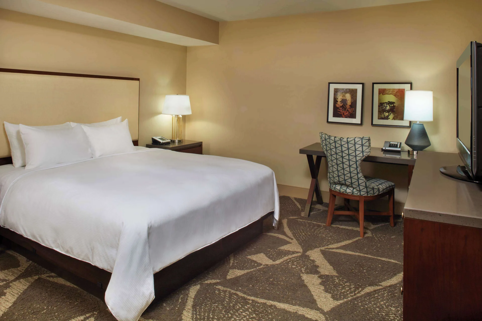 Accessible guest room with king bed, desk, chair and TV at Hilton Hawaiian Village Waikiki Beach Resort.