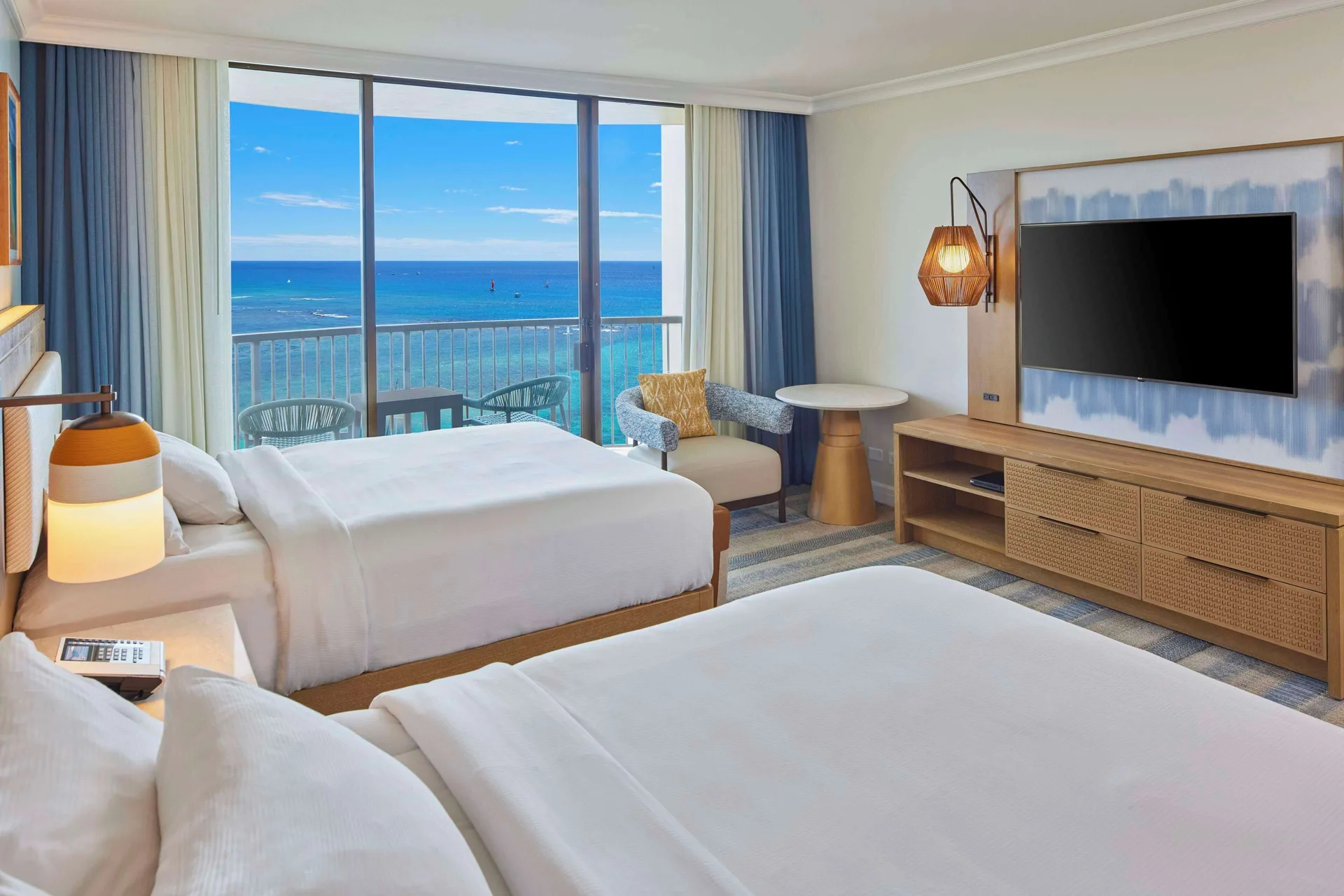Renovated Rainbow Tower guest room with two beds and ocean balcony at Hilton Hawaiian Village Waikiki Beach Resort.