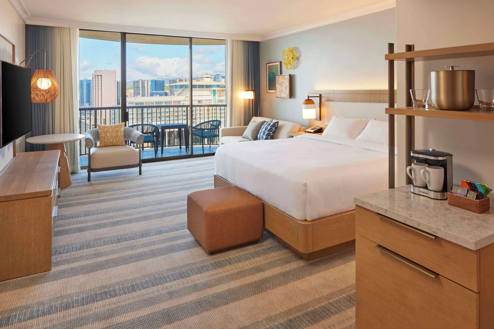 Renovated Ocean View room with king bed and refreshment station at Hilton Hawaiian Village Waikiki Beach Resort.