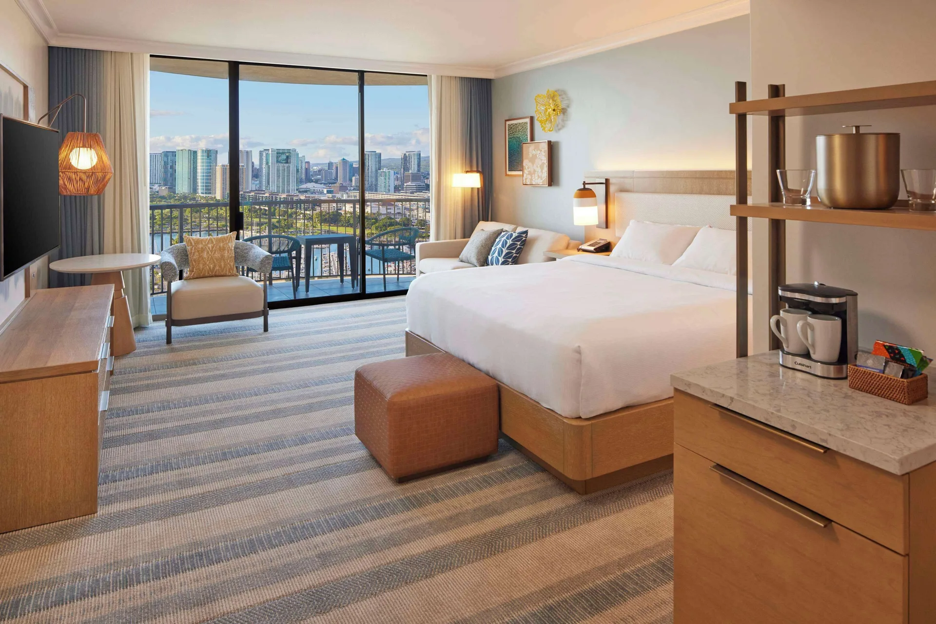King Ocean View room with sofa and skyline view at Hilton Hawaiian Village Waikiki Beach Resort.