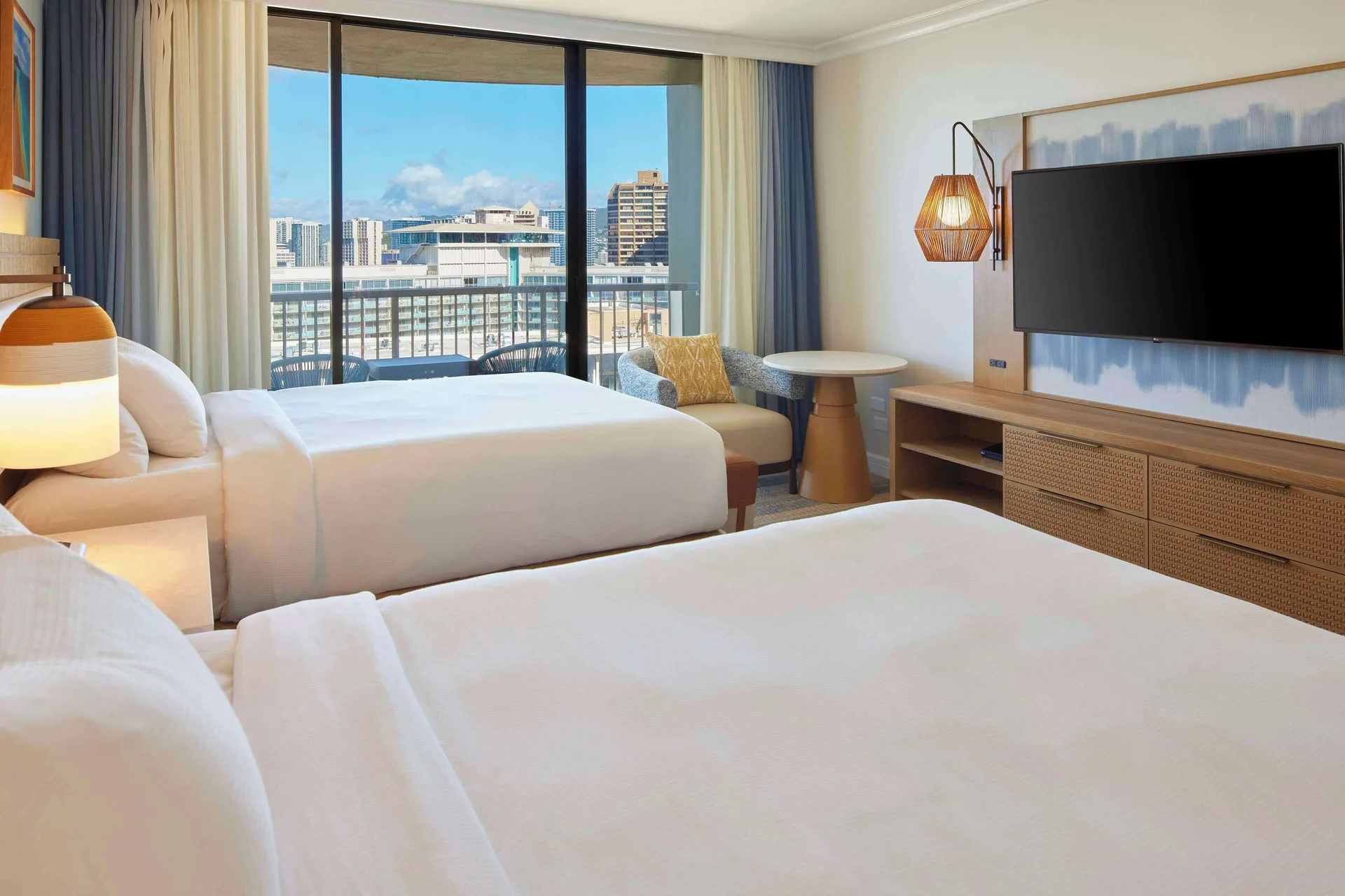 Two-bed Ocean View room with TV and balcony at Hilton Hawaiian Village Waikiki Beach Resort.