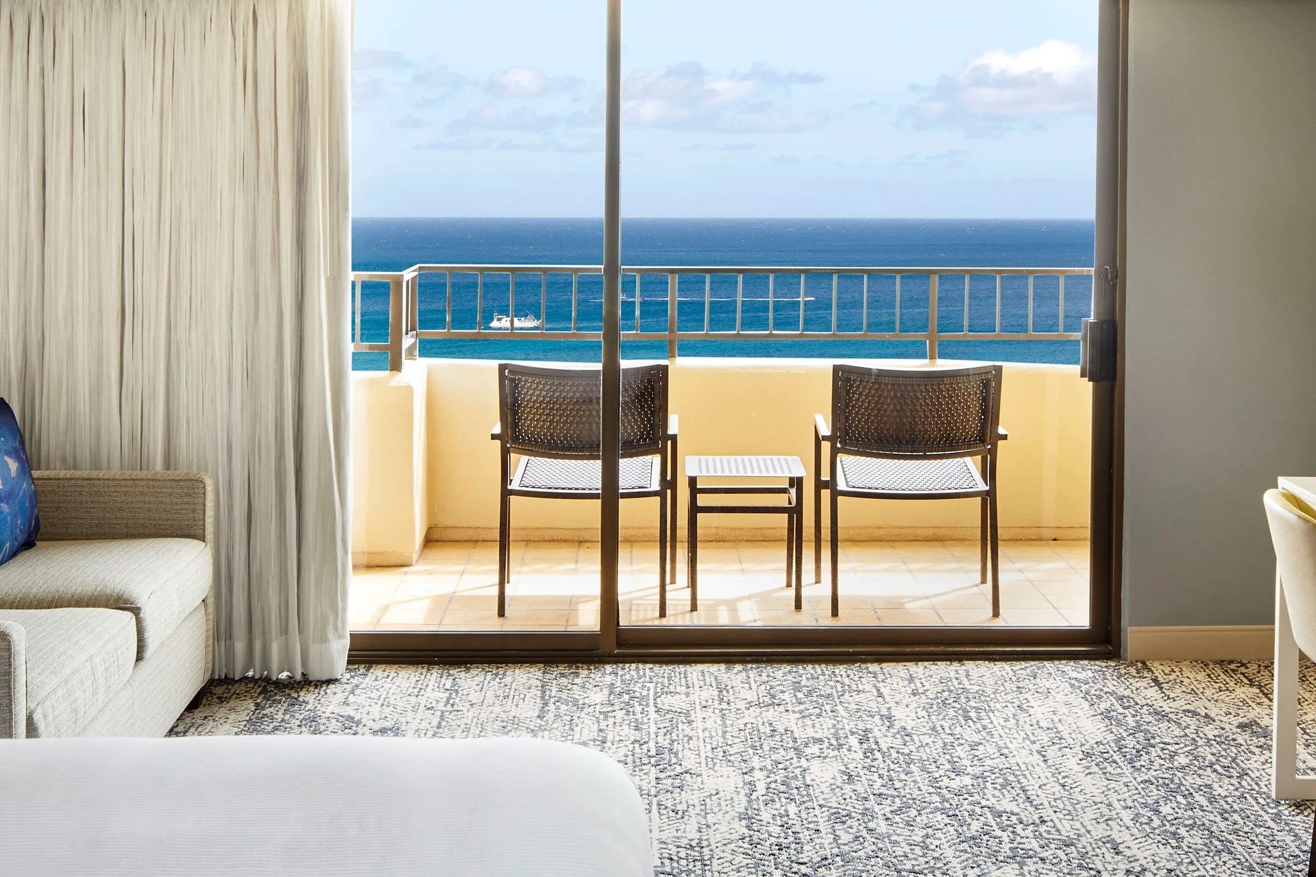Balcony and ocean view from a Tapa Collection room at Hilton Hawaiian Village Waikiki Beach Resort.