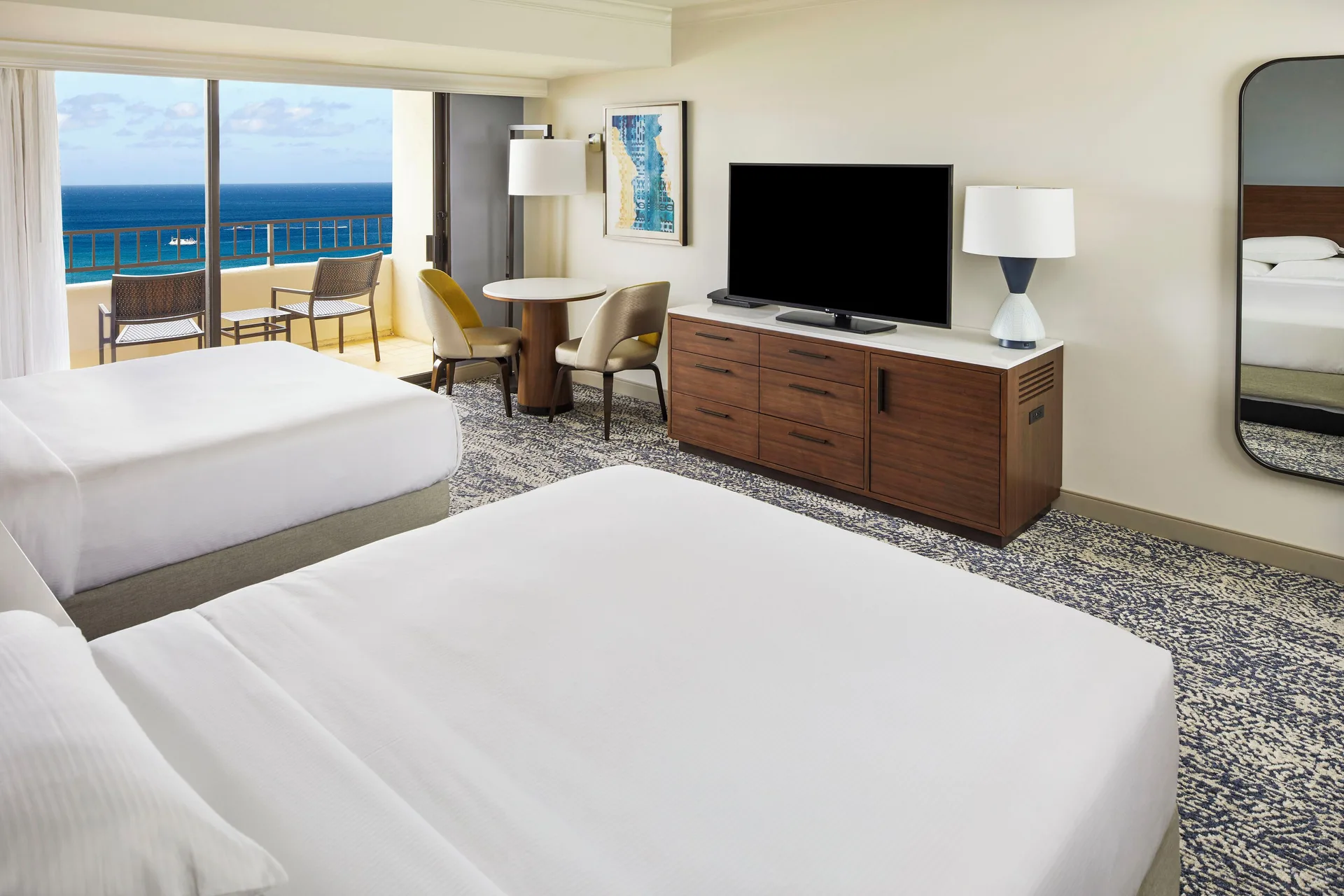 Two-bed ocean view Tapa Collection room with balcony at Hilton Hawaiian Village Waikiki Beach Resort.