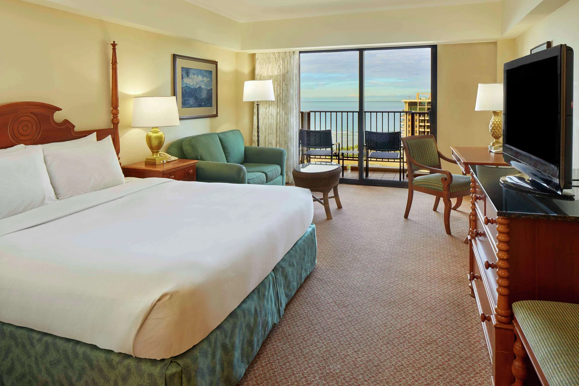 Ocean view king room with sofa and balcony at Hilton Hawaiian Village Waikiki Beach Resort.
