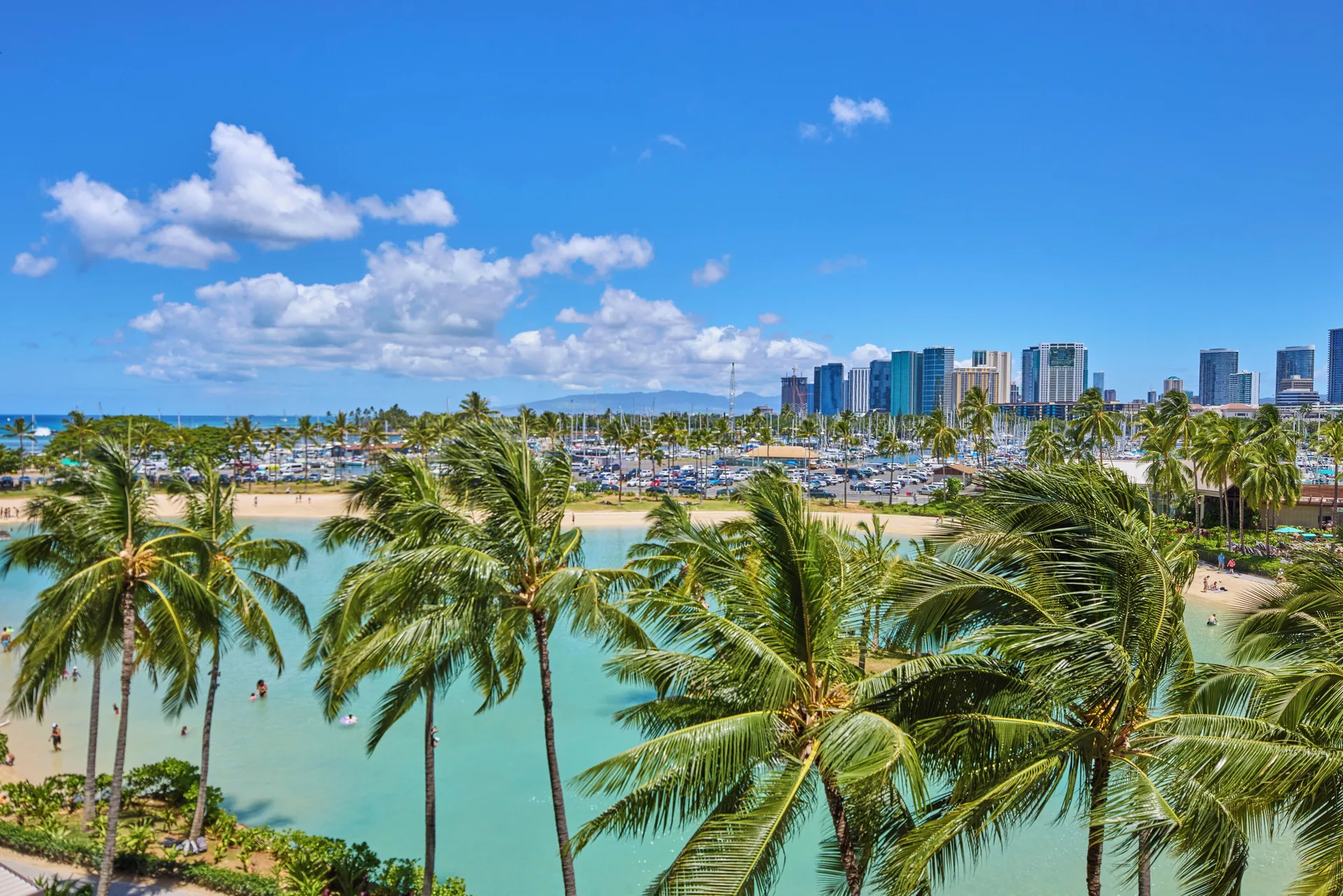 Balcony view of lagoon, palms, marina, and ocean at Hilton Hawaiian Village Waikiki Beach Resort.