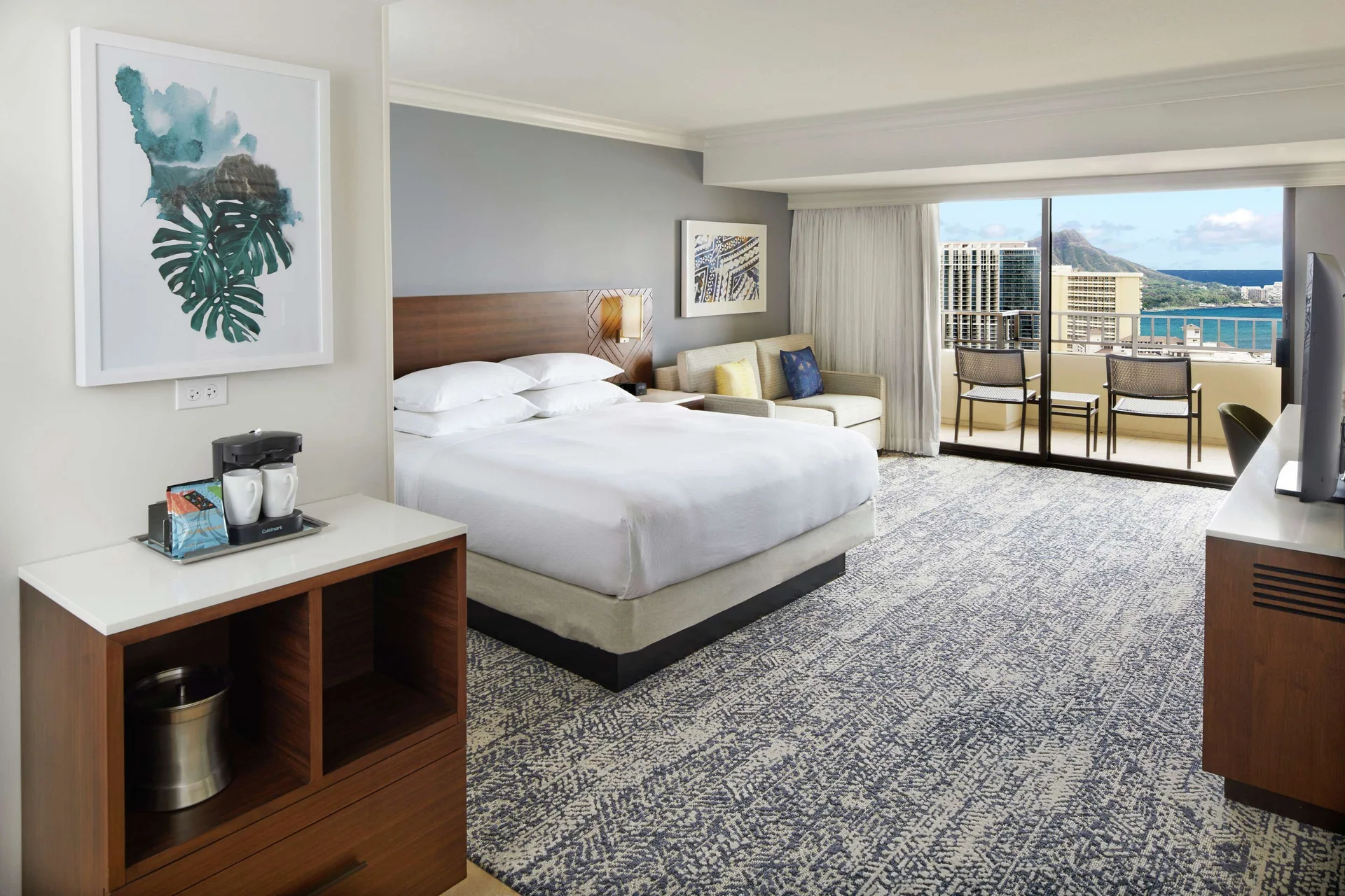 Tapa Collection partial ocean view room with king bed at Hilton Hawaiian Village Waikiki Beach Resort.