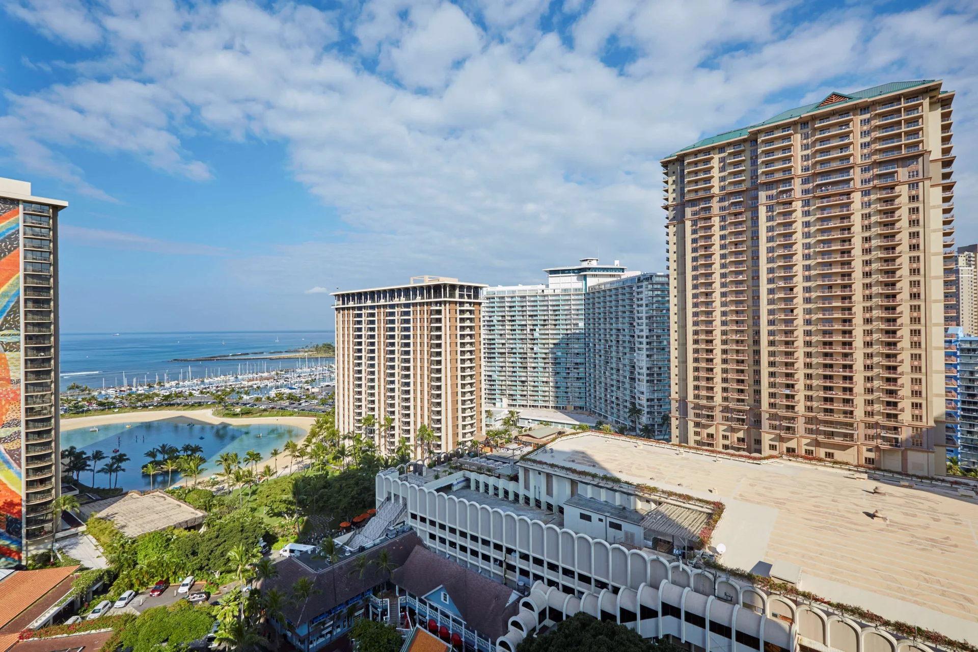 Resort view over towers, lagoon, and marina at Hilton Hawaiian Village Waikiki Beach Resort.