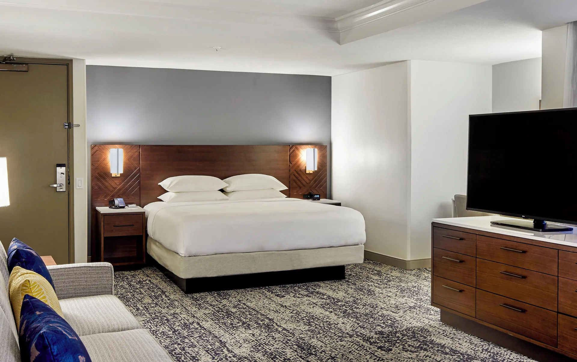King resort view room with sofa and TV at Hilton Hawaiian Village Waikiki Beach Resort.