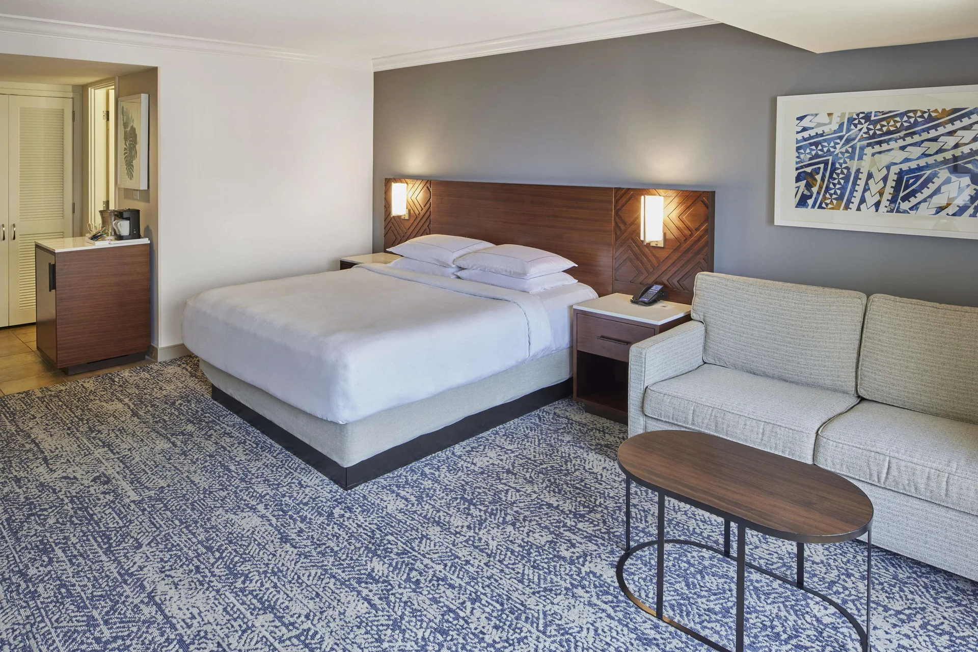 King guest room with sofa seating area at Hilton Hawaiian Village Waikiki Beach Resort.