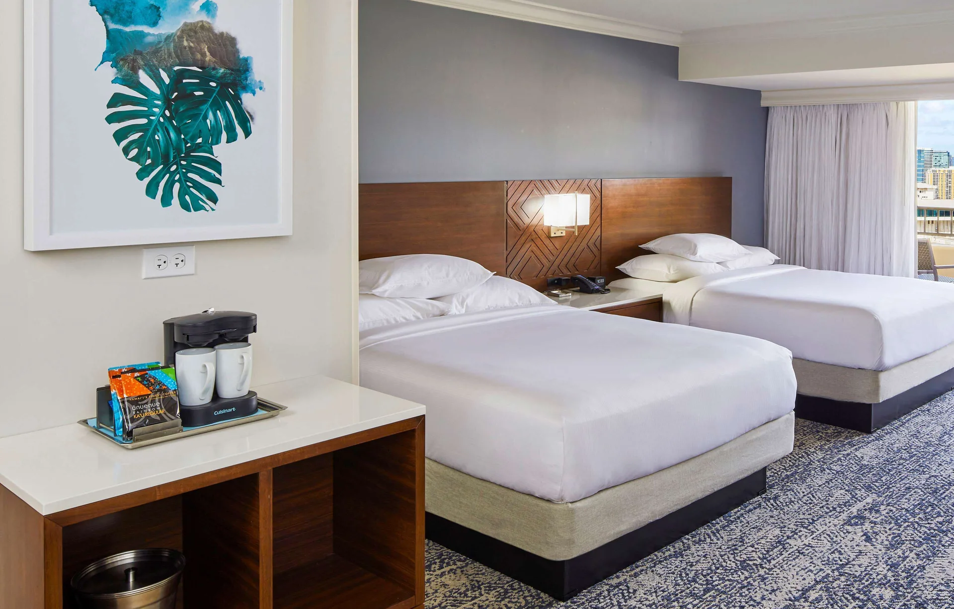 Two-bed guest room with coffee station at Hilton Hawaiian Village Waikiki Beach Resort.
