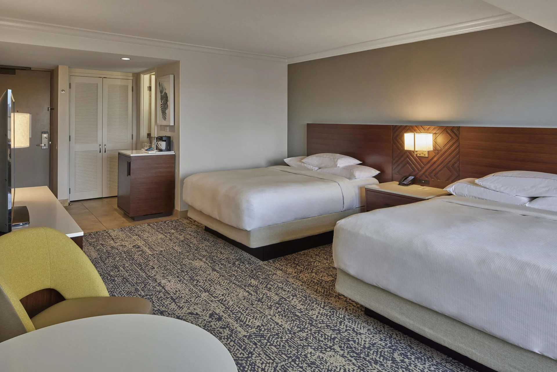 Two-bed resort view room from the seating area at Hilton Hawaiian Village Waikiki Beach Resort.