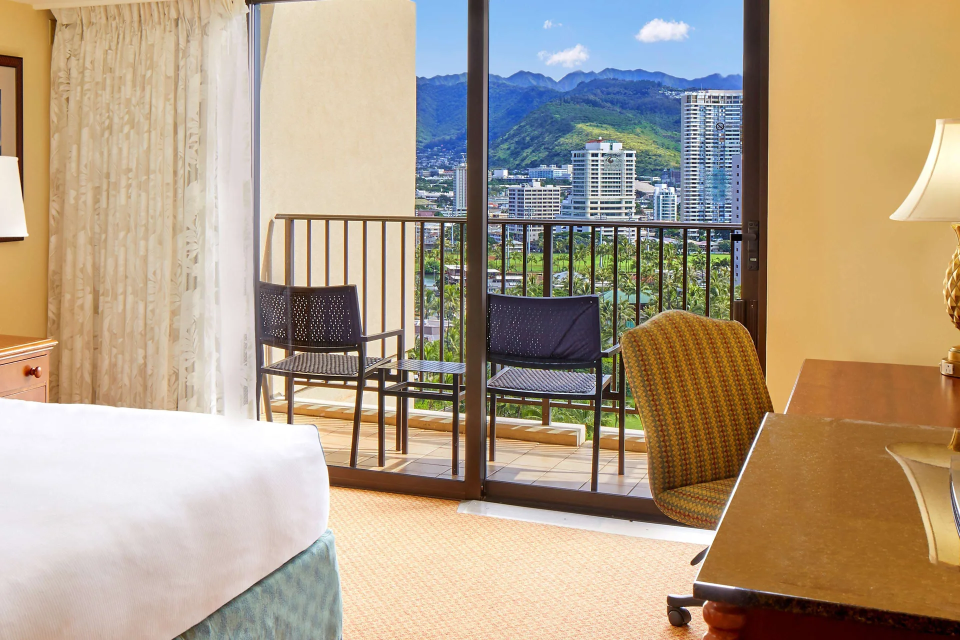 Resort view guest room with balcony seating at Hilton Hawaiian Village Waikiki Beach Resort.