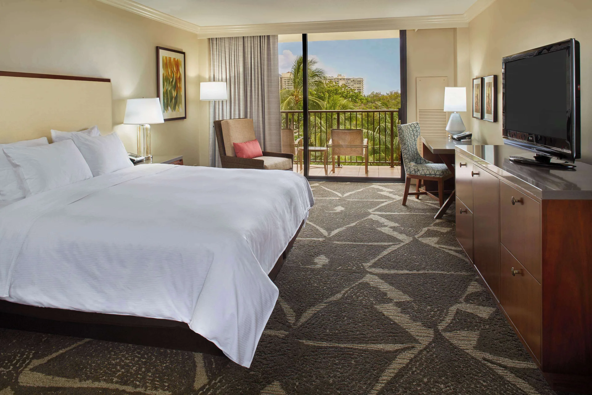 King resort view room with balcony and TV at Hilton Hawaiian Village Waikiki Beach Resort.