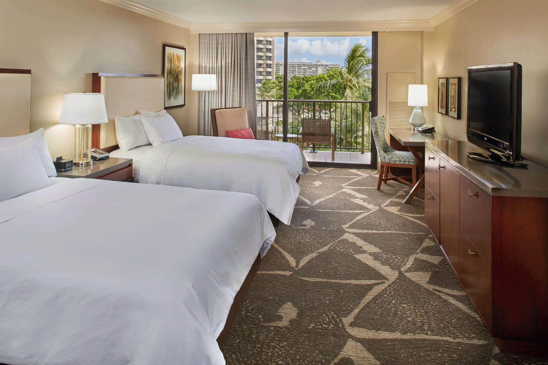 Two-bed resort view room with balcony and palm views at Hilton Hawaiian Village Waikiki Beach Resort.