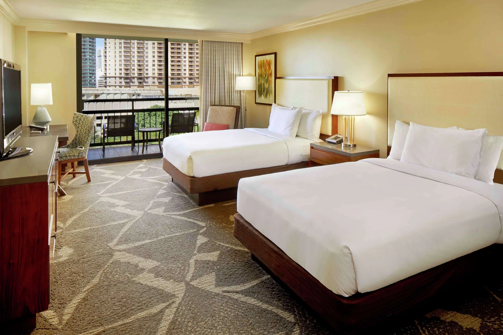 Bright two-bed resort view room and balcony at Hilton Hawaiian Village Waikiki Beach Resort.