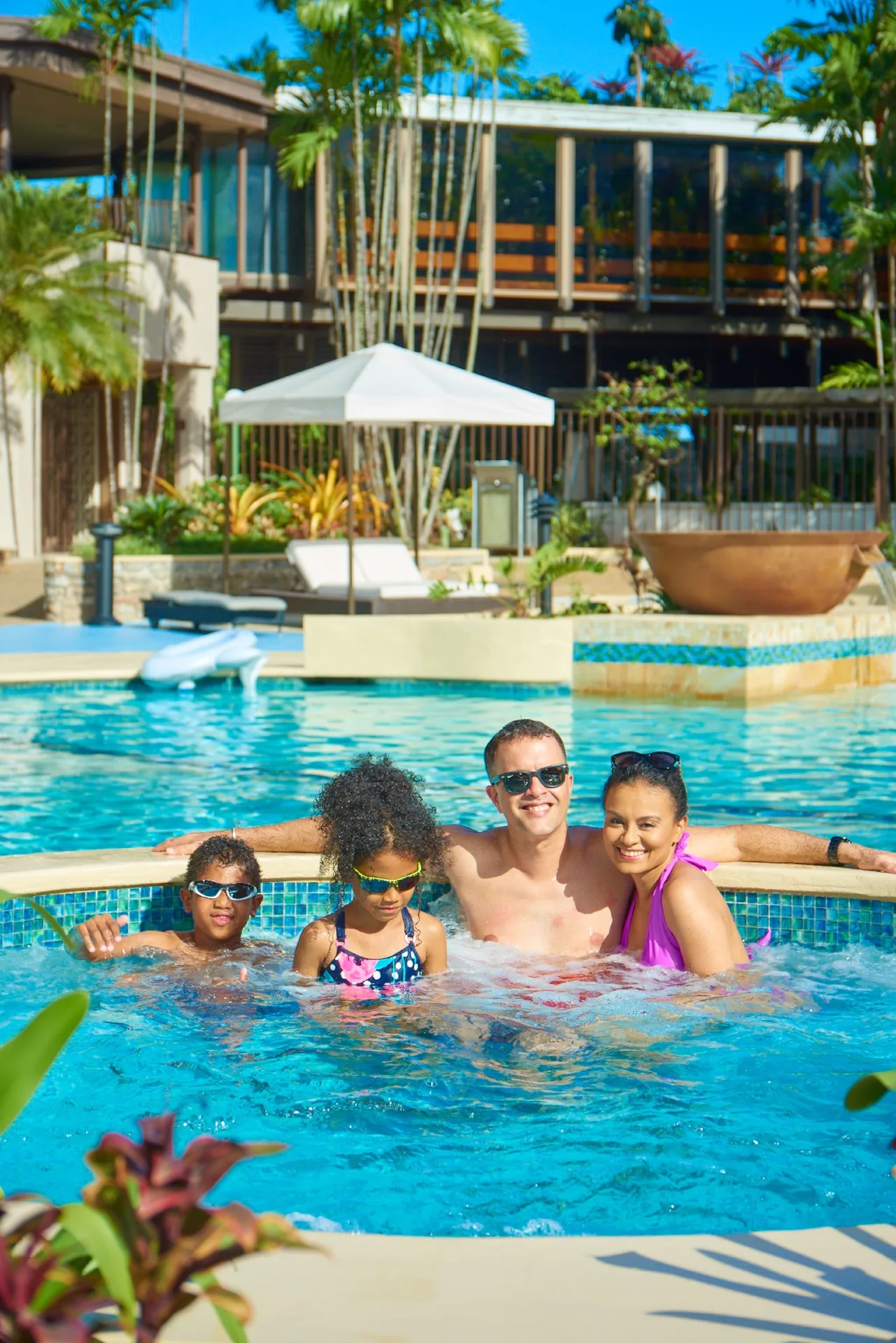 Family in the resort pool at Hilton Trinidad & Conference Centre.
