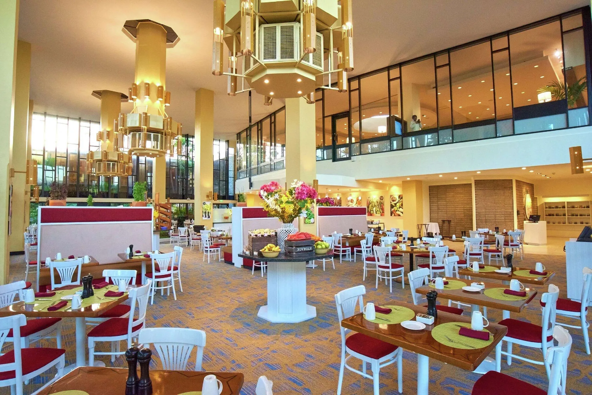 Bright dining room with set tables at Hilton Trinidad & Conference Centre.