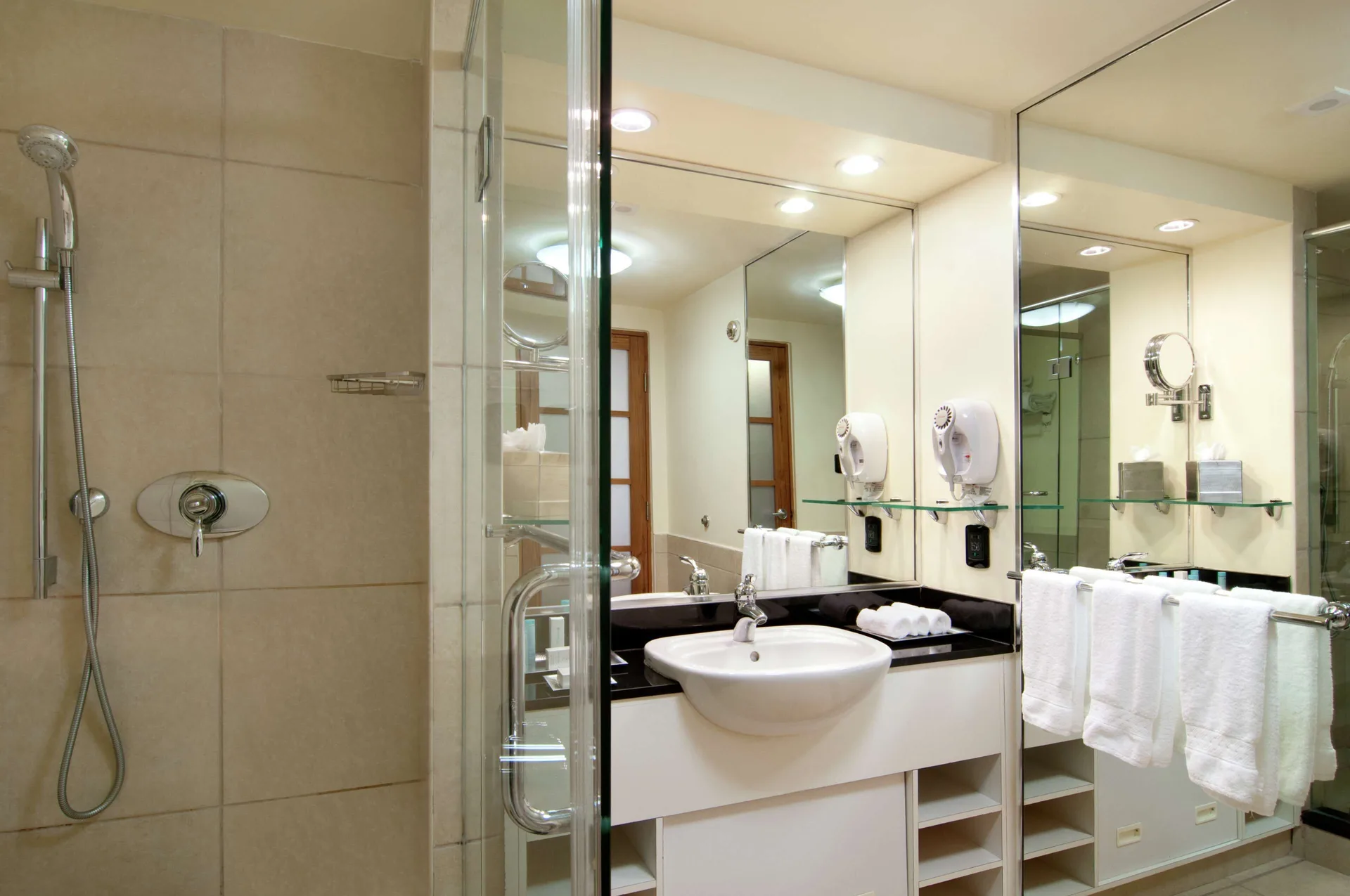 Executive Room bathroom vanity and glass shower at Hilton Trinidad & Conference Centre.