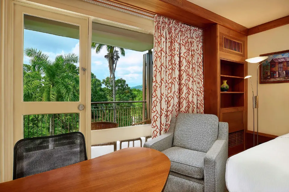 Executive Room sitting area by balcony doors at Hilton Trinidad & Conference Centre.