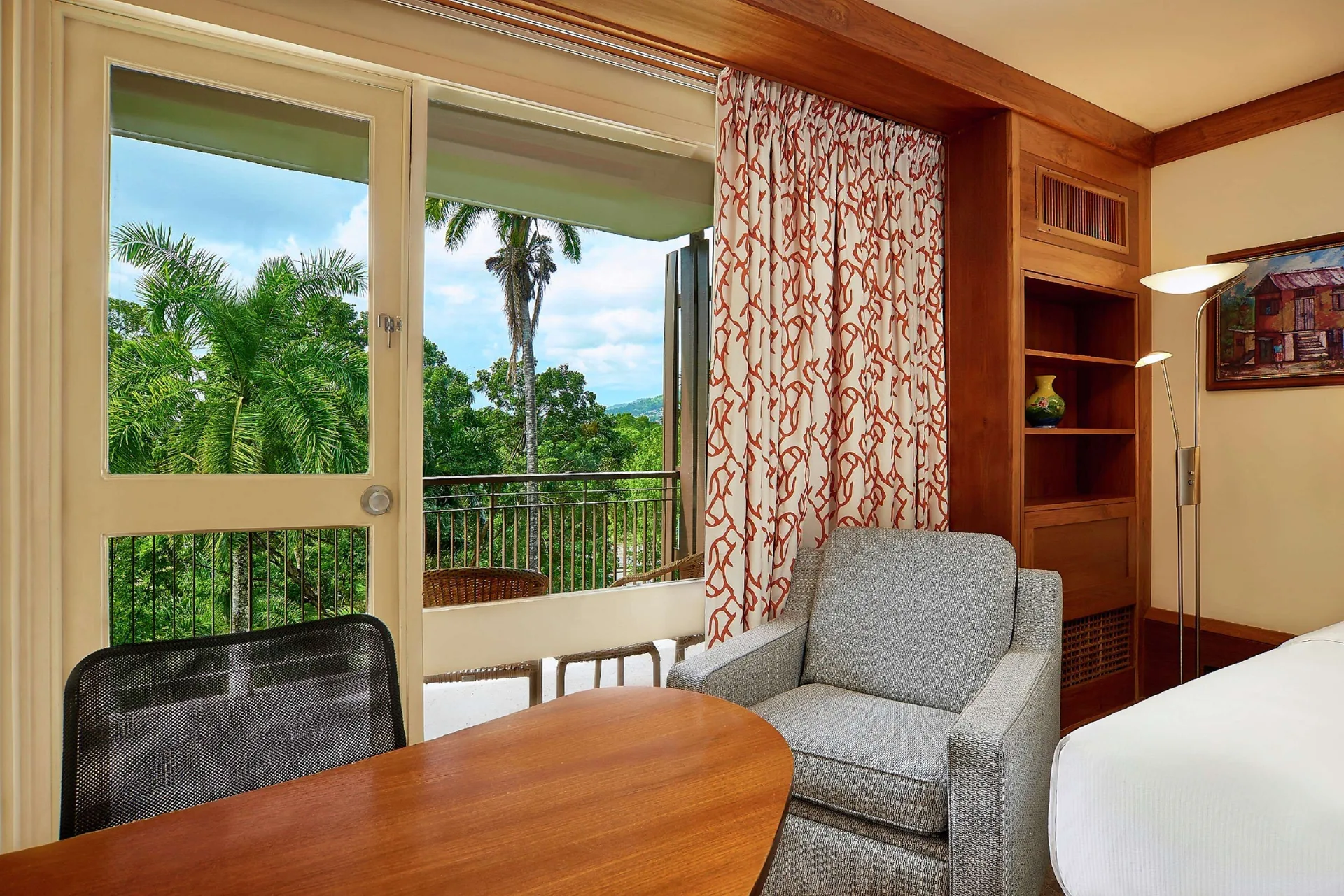 Executive Room sitting area by balcony doors at Hilton Trinidad & Conference Centre.