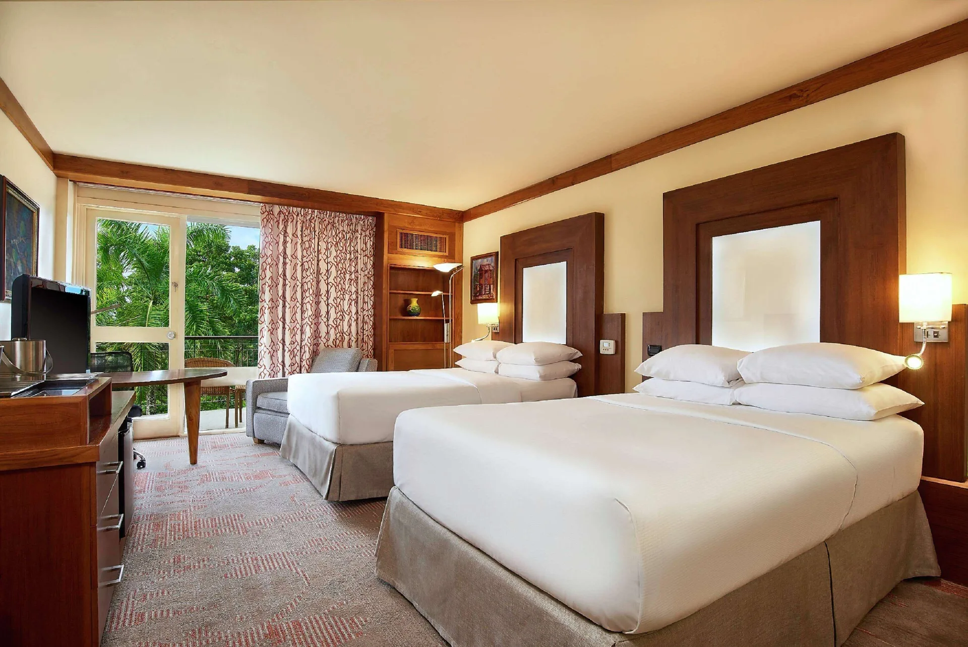 Executive Room with two beds and window seating at Hilton Trinidad & Conference Centre.