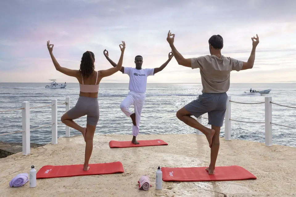 Yoga class faces the ocean from a terrace at HM Alma de Bayahibe.