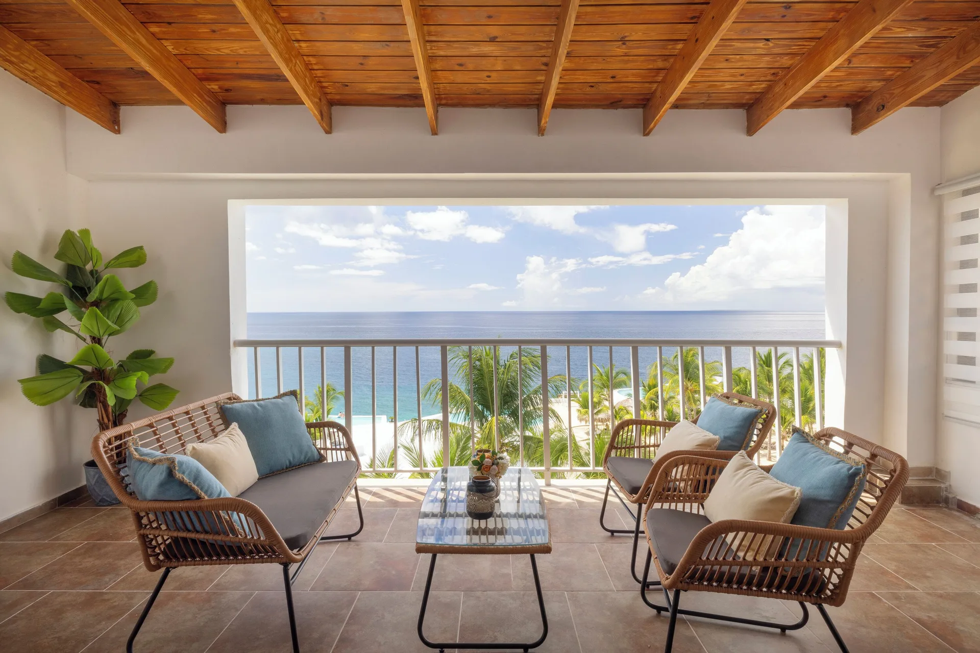 Junior Suite sea view balcony with wicker seating at HM Alma de Bayahibe.