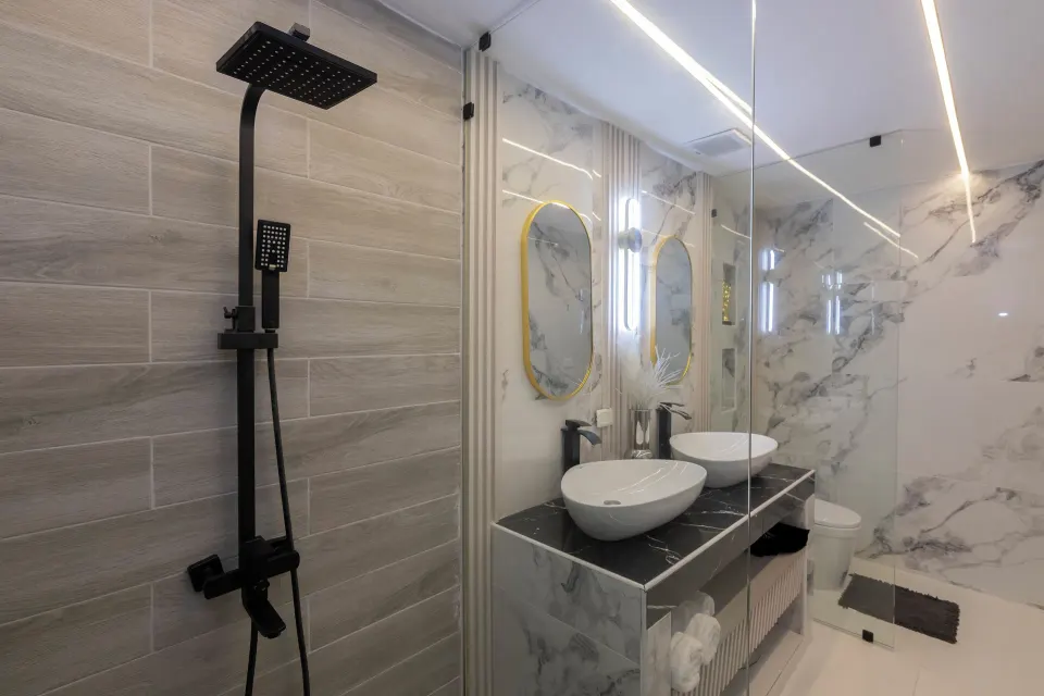 Junior Suite sea view bathroom with rainfall shower and double vanity at HM Alma de Bayahibe.