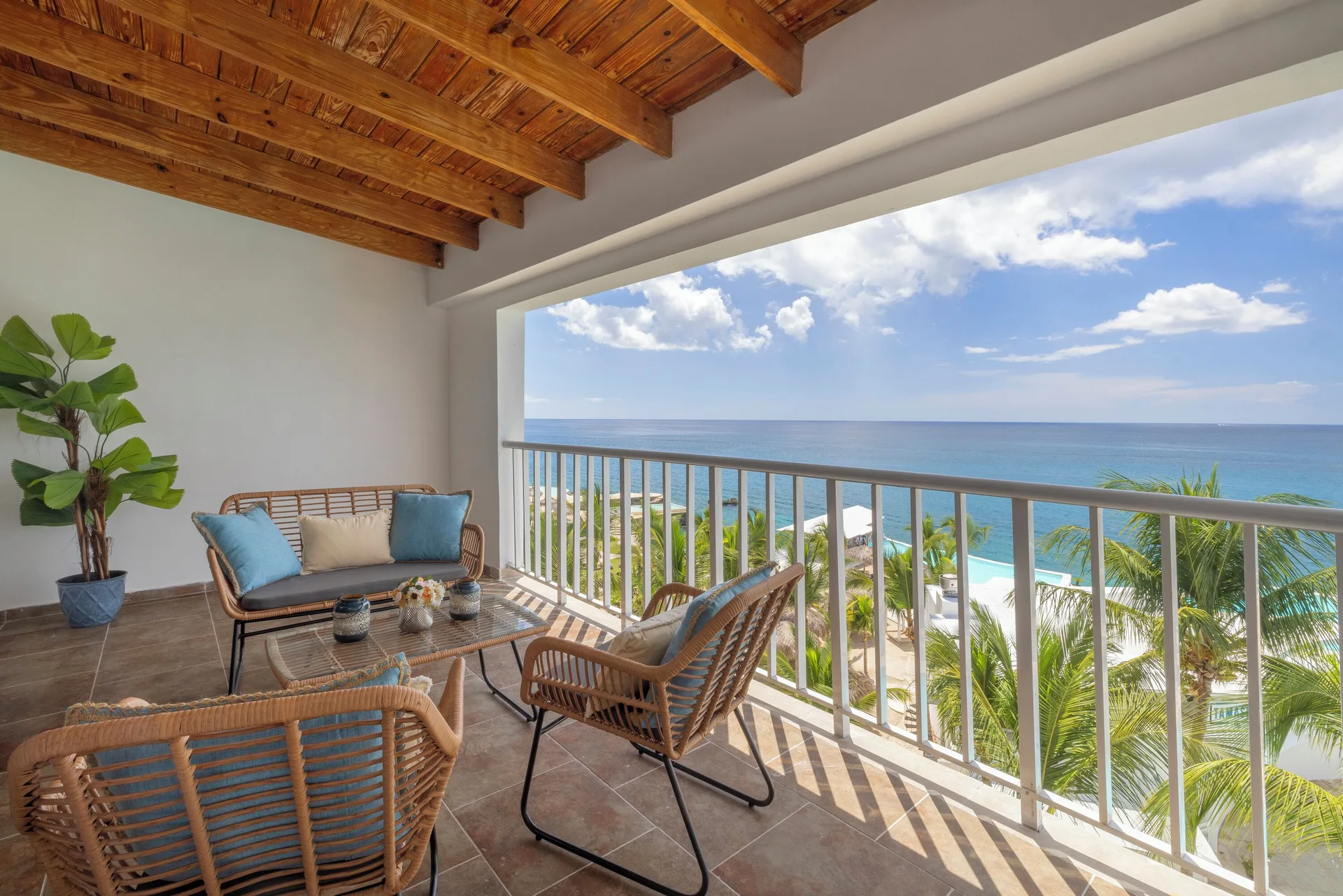 Junior Suite balcony with lounge chairs and ocean view at HM Alma de Bayahibe.