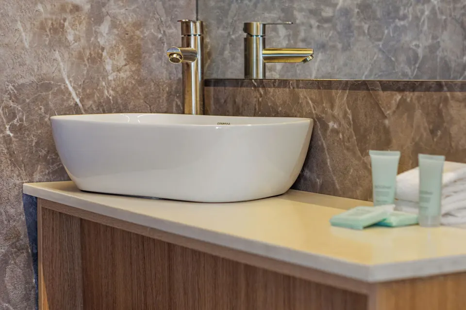 Junior Suite bathroom vessel sink and amenities at HM Alma de Bayahibe.