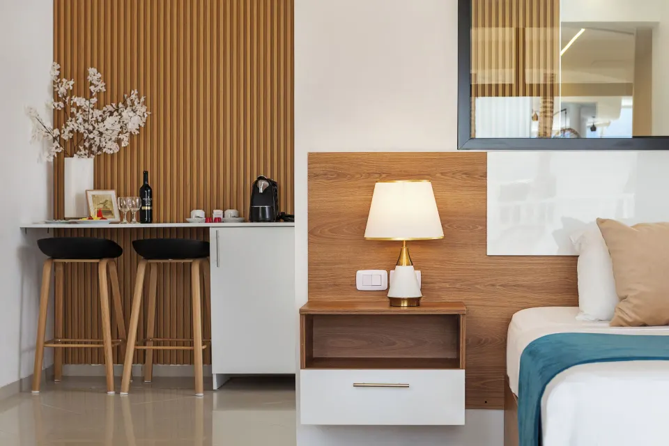 Junior Suite bedside lamp with coffee nook and stools at HM Alma de Bayahibe.