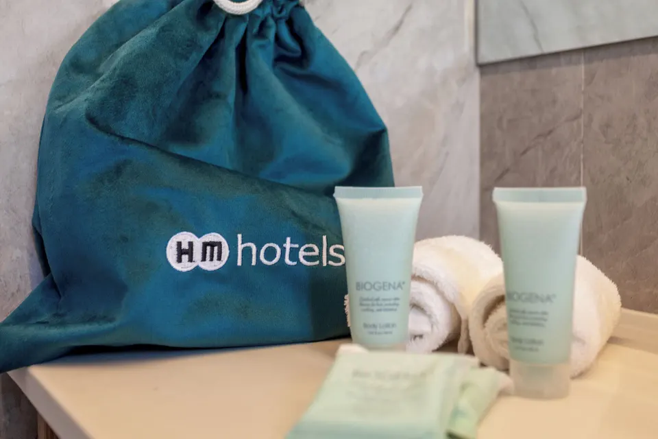 Bathroom amenities, towels and HM Alma de Bayahibe bag in a guest room at HM Alma de Bayahibe.