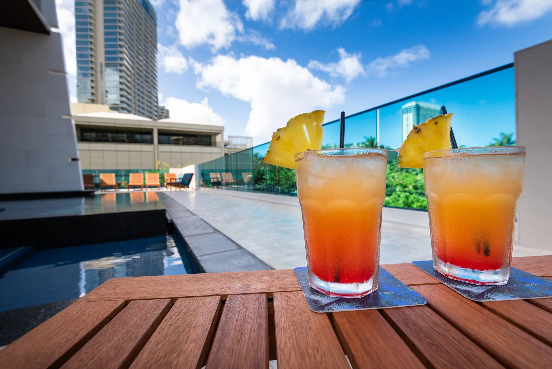 Two tropical drinks on a poolside table at Hotel La Croix.