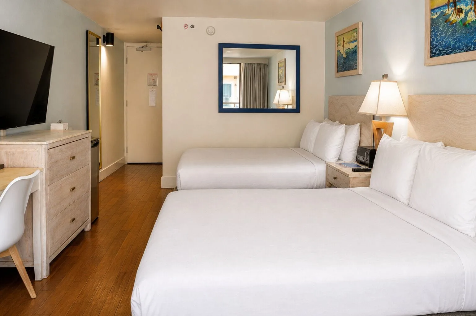 Wide view of two beds and desk in Ali'i Waikiki Two at Hotel La Croix.