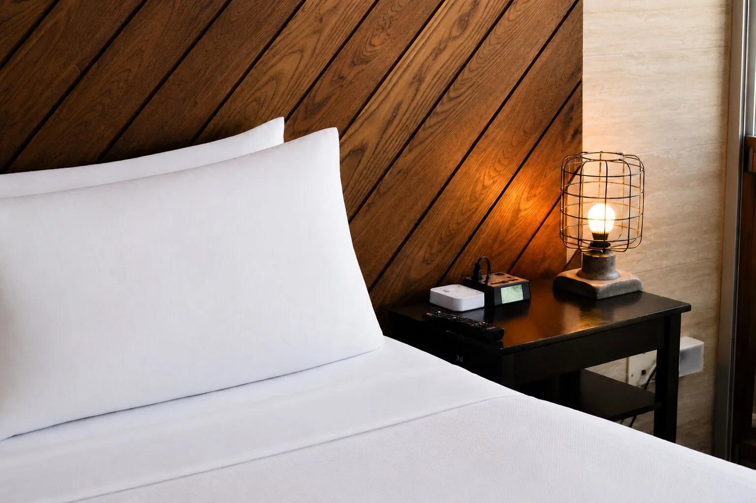 Penthouse Hoku Skyline Honolulu bed and bedside lamp at Hotel La Croix.